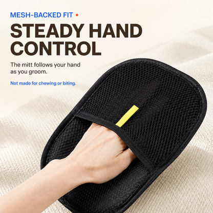 Hand secured under the mesh back strap of a black pet grooming mitt