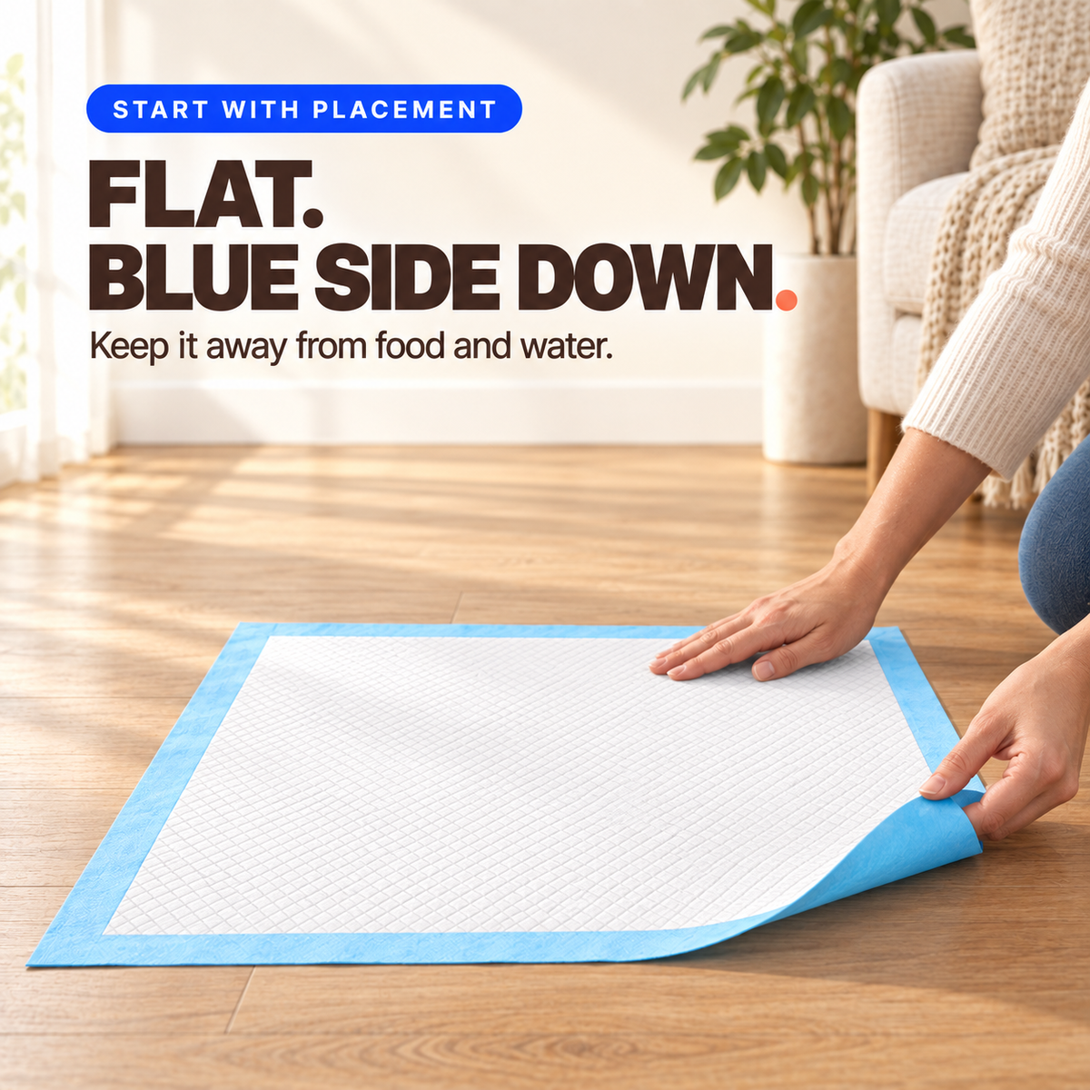 Hands place a disposable pet training pad flat with the white side up and blue side down.