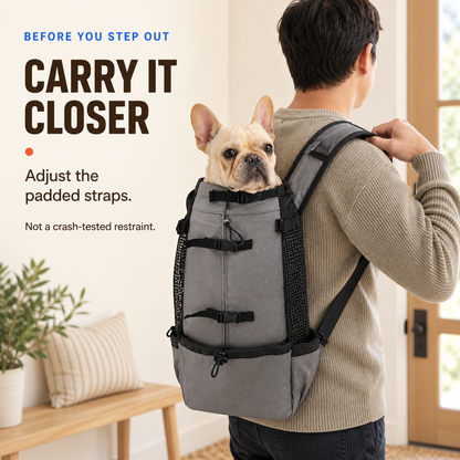 Adult adjusts a padded shoulder strap on the Dark Grey pet carrier backpack before a supervised outing.