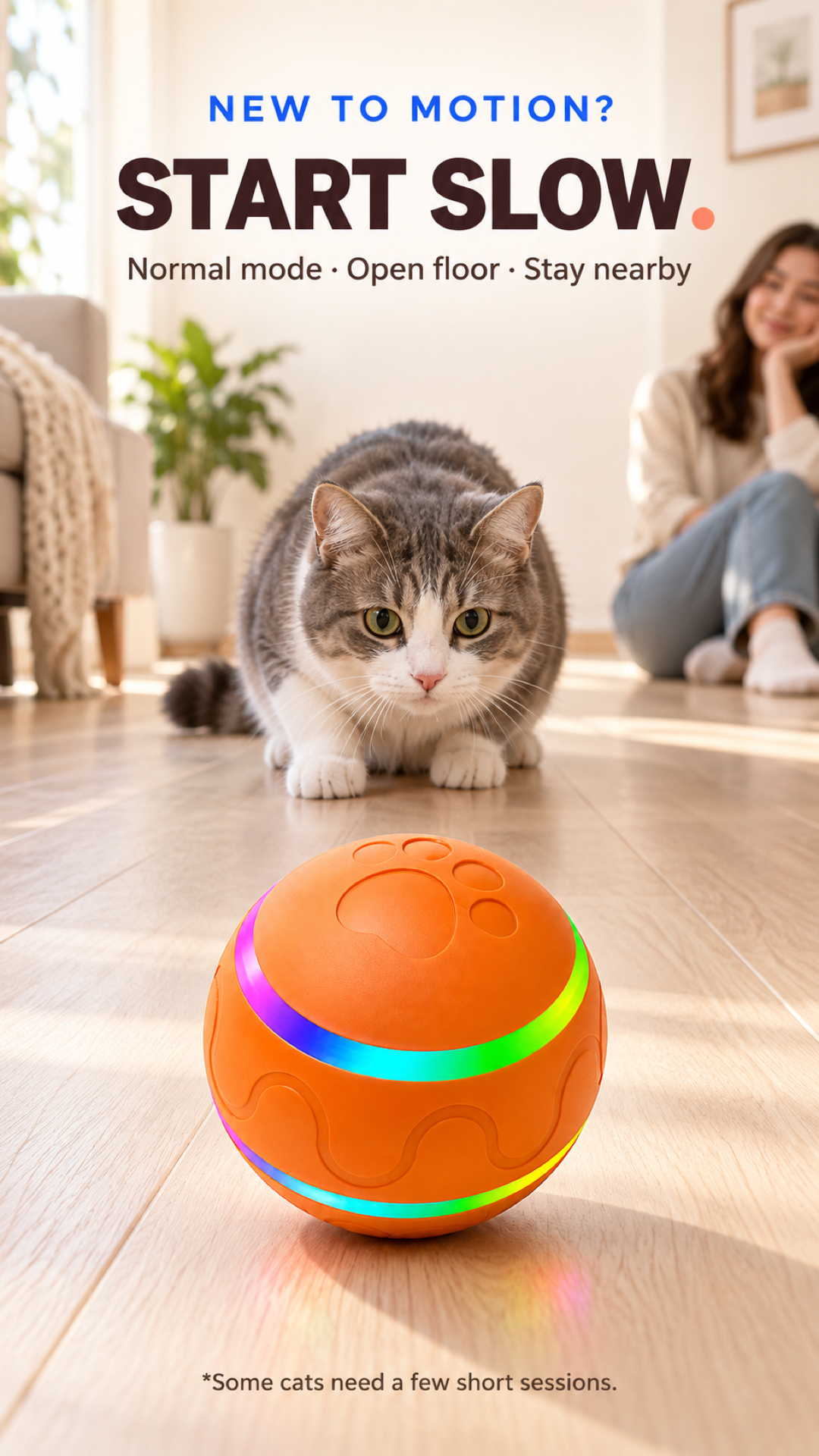 Vertical first-play scene with a cat watching the orange automatic rotating ball