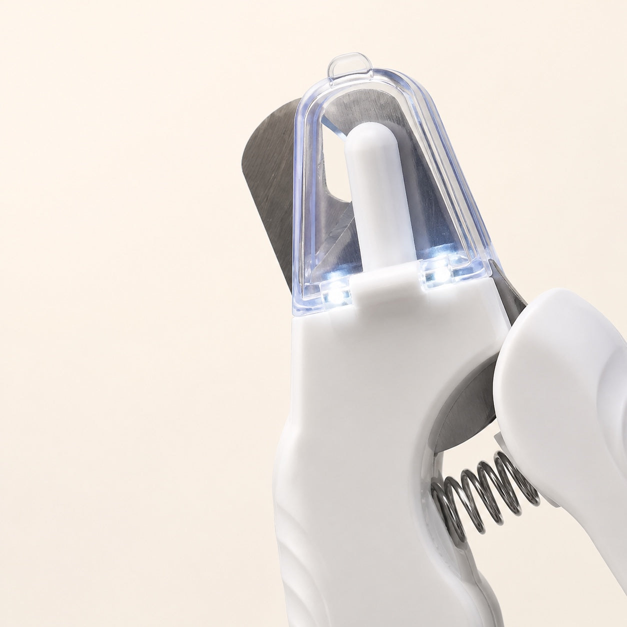 Close view of the white pet nail clipper head with both LED lights switched on